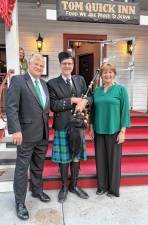 Master of Ceremonies Joseph Dooley with bagpiper Jeff McQuaid and event coordinator Maureen Dooley.