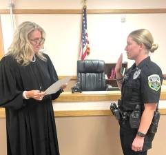 Judge Cristin Cavallaro swears in Officer Alexis Fader.