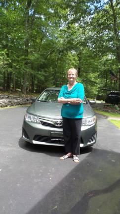 Marion Foran with the new car she needed to buy after her mint-condition Camry was destroyed on Sawkill Road on April 1. She wasn't making car payments before her accident -- but she has to now. (Photo by Frances Ruth Harris)