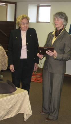 Photos provided Phyllis D. receives a plaque of appreciation from Martha D., Executive Director of GAIT TRC.