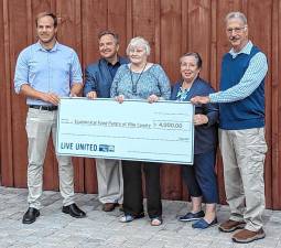 Will Craven (left), manager of Impact Funding for the United Way of Lackawanna, Wayne, and Pike Counties presents a symbolic check to pantry volunteers Steve Shay, Nancy Potter, Allyson Gillinder, and Jim Snodgrass.