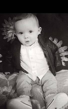 Photo, Daniel Doellinger of Chester Charlie in leather jacket at 5 months old.