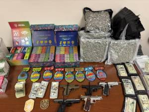 The drugs, weapons, and cash seized as part of the raid.