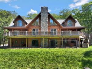 Upscale craftsman-style log home has a lake view and room for all