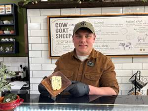 Adam Kolman holding a delicious blue cheese.