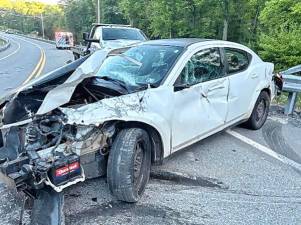 The vehicle struck the guard rail before coming to a stop in the middle of the lane.