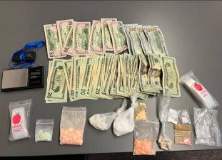 The cash, drugs, and materials allegedly seized from the home, per DA Tonkin.