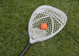 A lacrosse goalie’s stick with ball.