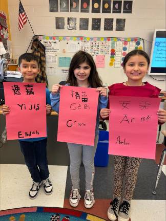 Elijah Rivera, Grace Flathmann, and Amber Been-Rojas learn about the Chinese New Year.