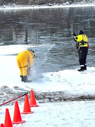 Fire department members cut through the ice of the Delaware River in preparation for the sixth annual Polar Plunge.