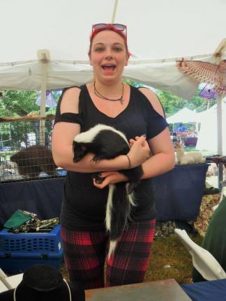 Ali Machirone of Pocono Wildlife Rescue holds a skunk that - luckily - has been de-scented.