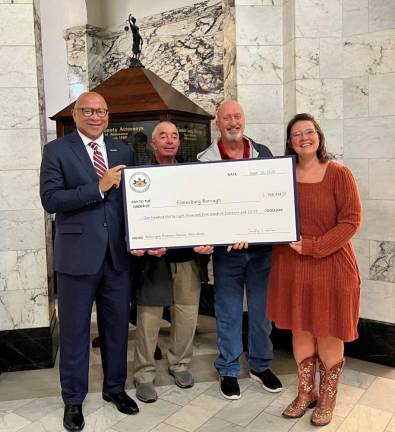 Auditor General Timothy L. DeFoor delivers a symbolic municipal pension plan disbursement check to a local municipal in Cambria County.