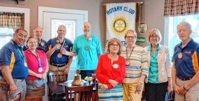Rotary members celebrate their new president as a recent meeting.