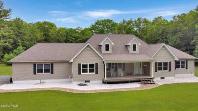 Modern three-bedroom ranch on 11+ acres with apple and peach trees