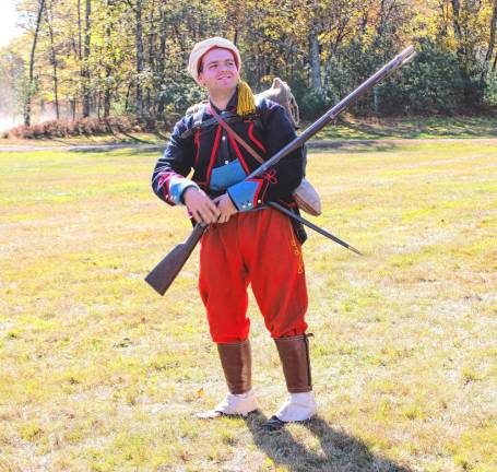 A soldier in red with gun in hand.