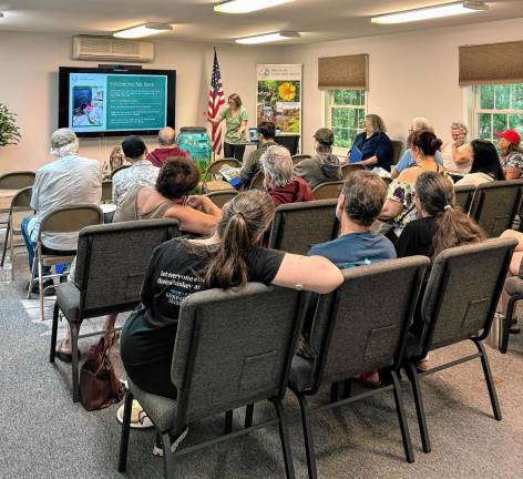 Attendees learn about rain barrel installation and maintenance at the Barrels &amp; Breakfast program.