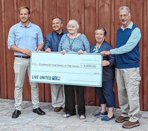 Will Craven (left), manager of Impact Funding for the United Way of Lackawanna, Wayne, and Pike Counties presents a symbolic check to pantry volunteers Steve Shay, Nancy Potter, Allyson Gillinder, and Jim Snodgrass.