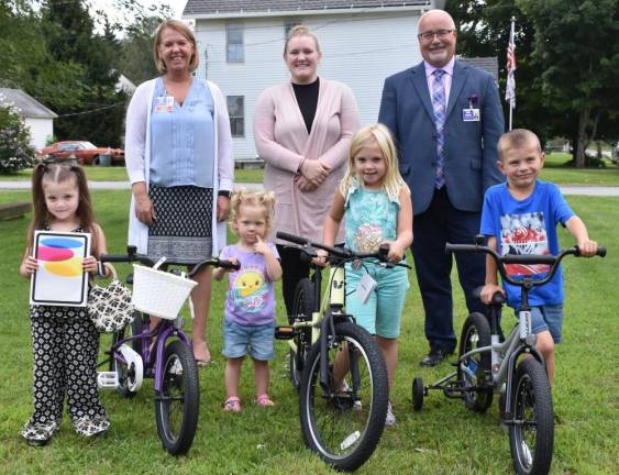 L-R Front: Aurora Ritz, Peyton Smith, Laila Langone, and Kayden Kelly. Summer Heenan was absent when the photo was taken. L-R Back: CEO Teresa Lacey, executive assistant Katelyn Haytko, and CFO Robert Fortuner.