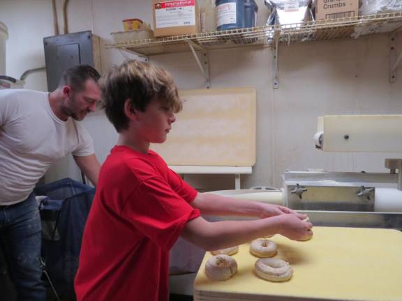 Hunter Conklin rolling bagels.