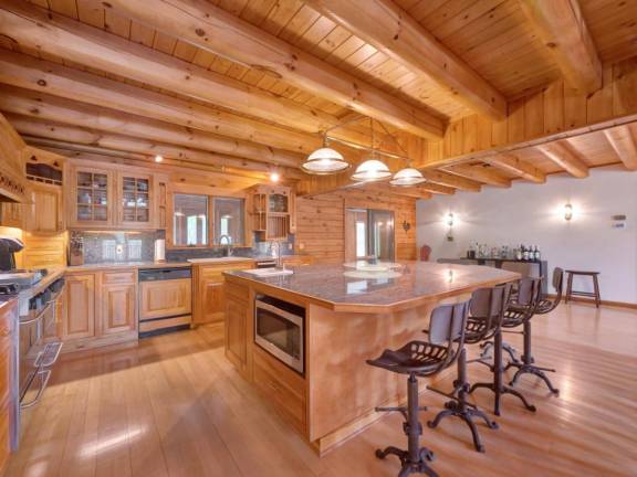 Upscale craftsman-style log home has a lake view and room for all