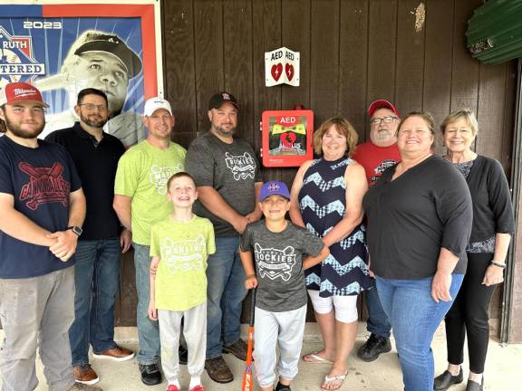 Camden Bunting, Tanner Cottell (front row) with (back row) Matt Abbott, Chris Tallman, Paul Bunting, Adam Cottell, Rotary Past President Sherry Grandinetti, current President Dana Scott, Charlie Rollison, and Rotarian Lisa Champeau.