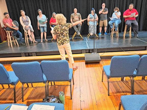 Musical Director Sandy Stalter in rehearsal with cast members.