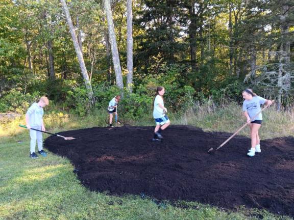 The middle schoolers were hard at work turning the soil in preparation for planting.