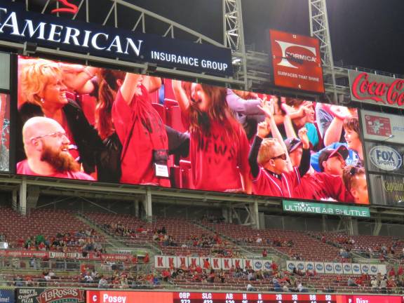 Photo provided DV newscasters projected onscreen at the Reds vs. Giants game.
