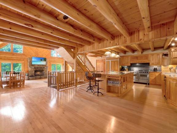 Upscale craftsman-style log home has a lake view and room for all