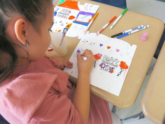 Madisyn Colon coloring her Valentine’s box (Photo by Ped Snure)