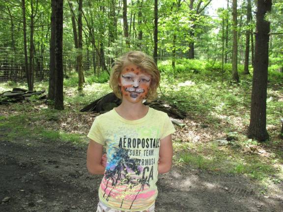 Hannah Chappell with a pretty, smiling, lion painted face.