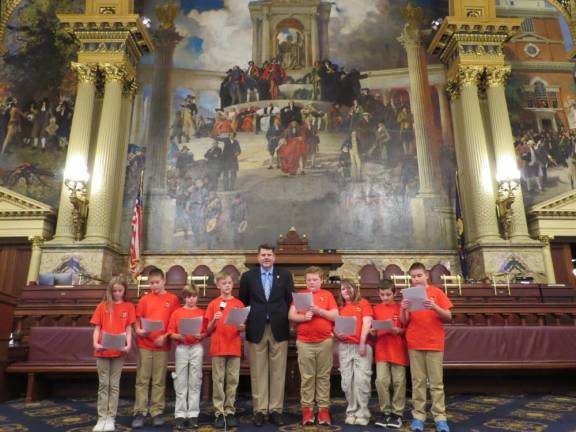 L-R: Morgan Babb, Theodore Stierle, Russell Fowler, Jackson Cabrera, Representative Jeff Olsommer, Logan Cuttler, Kelsie, Johnson, Maverick Poveda, and Jason Stierle on the House floor.