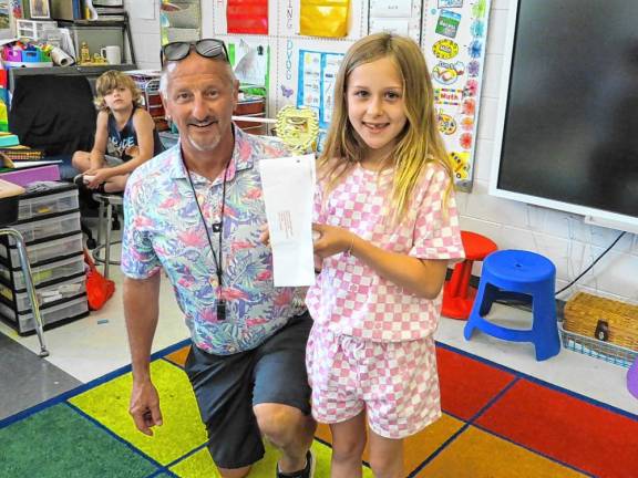 Elementary school student Brynn Holtzer with teacher Chris Neidig.