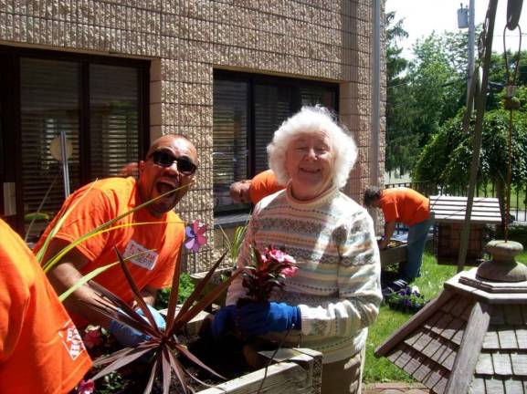Photo provided A volunteer from Home Depot with Belle Reve resident Priscilla Roth.