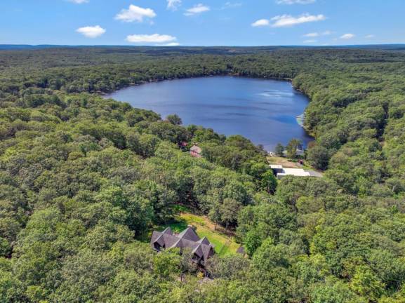 Upscale craftsman-style log home has a lake view and room for all