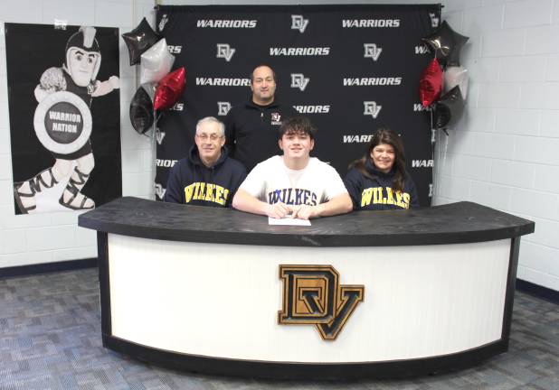 L-R Front: Philip DellaBella, Christopher DellaBella, and Colleen DellaBella. L-R Back: Head wrestling coach and high school principal Lou DeLauro.