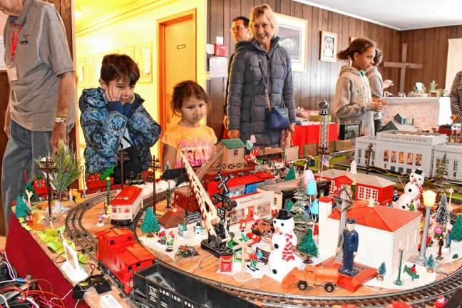 <b>Luke and Maggie Gibson of Oak Ridge look at the Holiday Train Display on Saturday, Nov. 23 at Prince of Peace Lutheran Church in Hamburg. (Photo by Maria Kovic)</b>