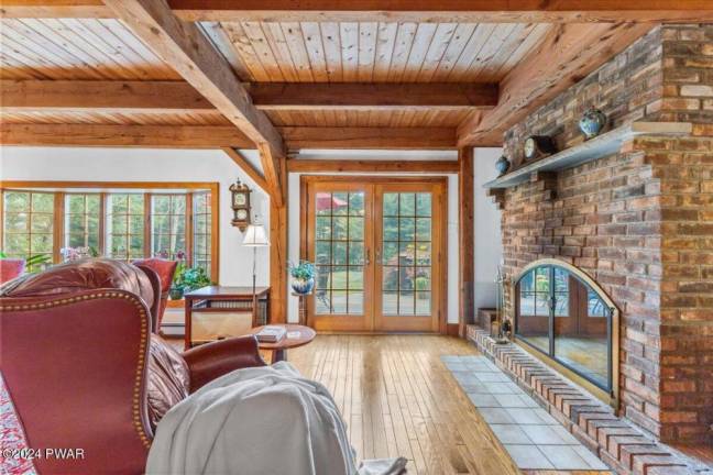 Cedar-sided, custom post and beam home surrounded by nature