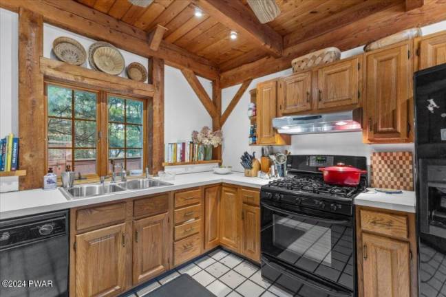 Cedar-sided, custom post and beam home surrounded by nature