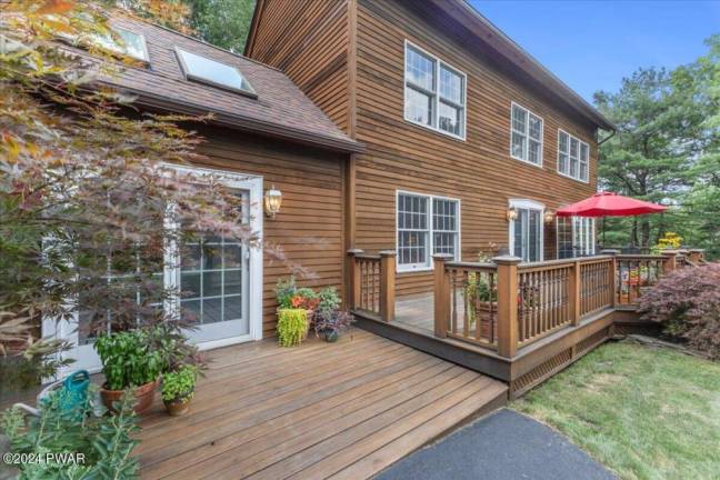 Cedar-sided, custom post and beam home surrounded by nature