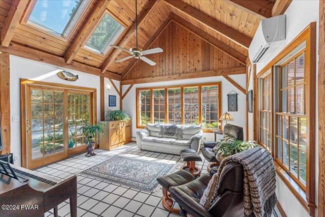 Cedar-sided, custom post and beam home surrounded by nature