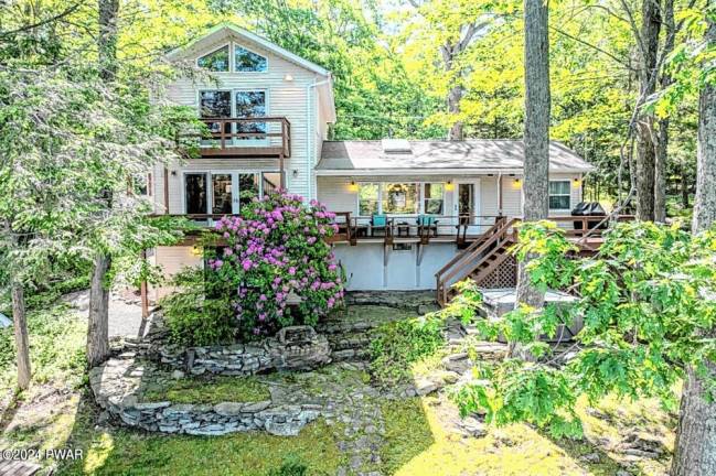 Lakefront home features custom boathouse, dock, and much more