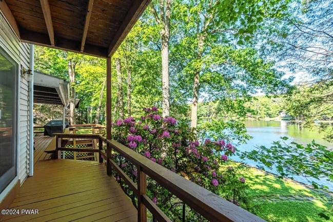 Lakefront home features custom boathouse, dock, and much more