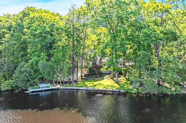 Lakefront home features custom boathouse, dock, and much more