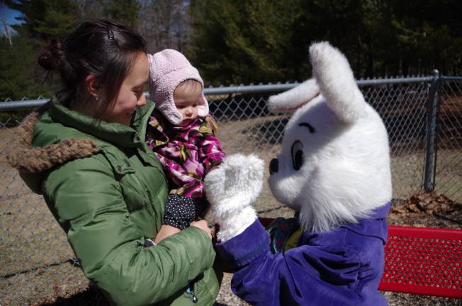 20 month old Pao Lin Fisher of Dingmans Ferry high fives the Easter Bunny.