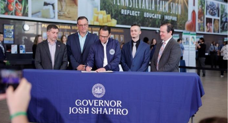 Gov. Josh Shapiro signs the executive order.